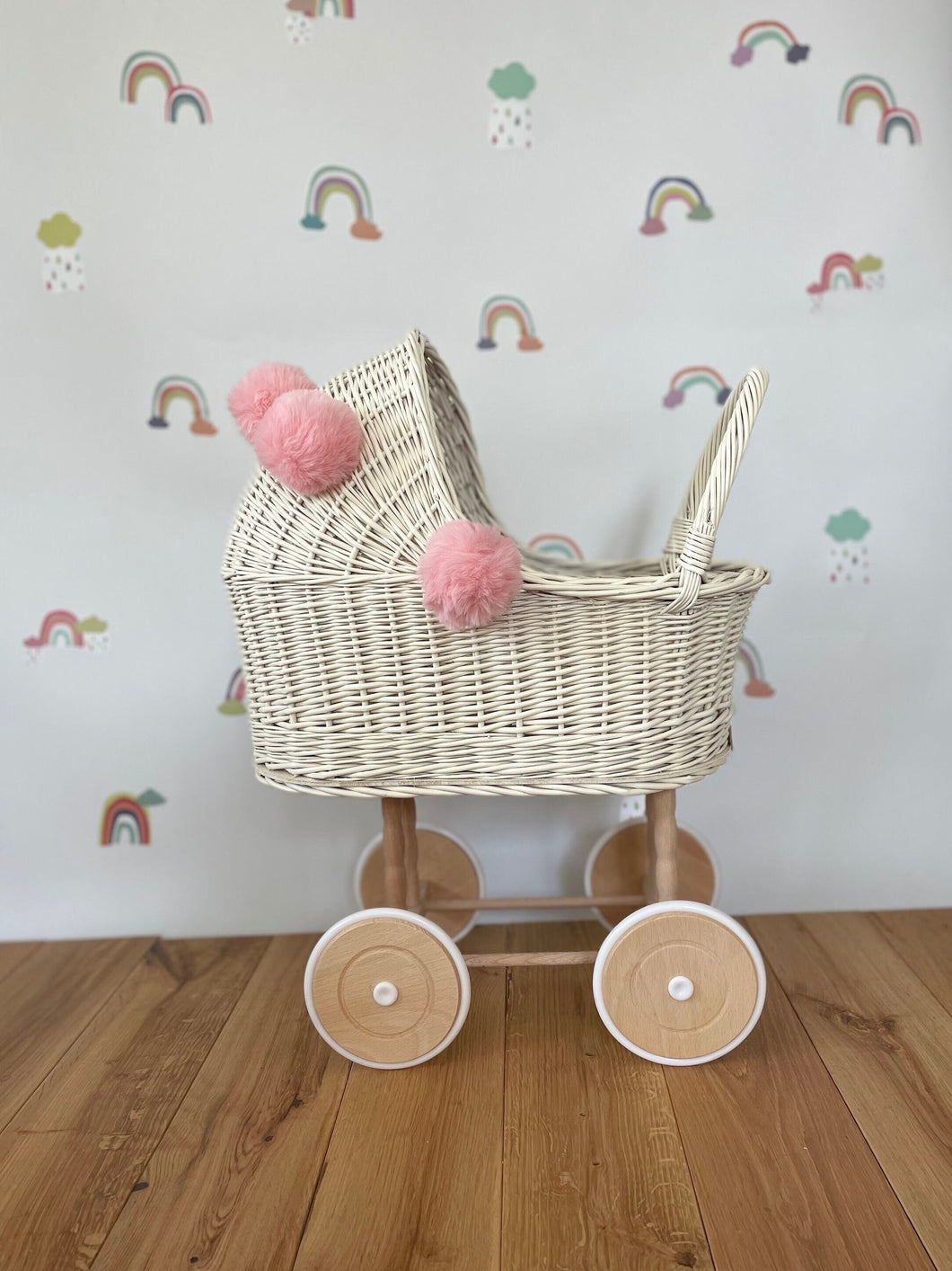Wicker pram with bow, tall dolls pram, bow and bedding included. Cream/ off white pram with light pink pom-poms and bedding of your choice.
