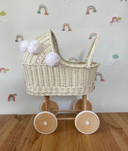Load image into Gallery viewer, Wicker pram with bow, tall dolls pram, bow and bedding included. Cream/ off white pram with white pom-poms and bedding of your choice.
