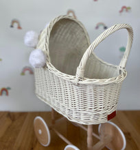 Load image into Gallery viewer, Wicker pram with bow, tall dolls pram, bow and bedding included. Cream/ off white pram with white pom-poms and bedding of your choice.
